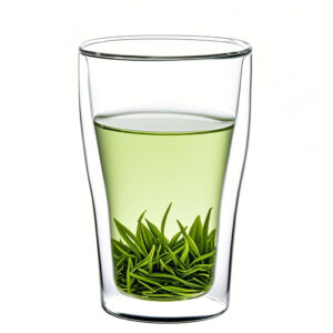 Brewed green tea in a clear glass tea cup