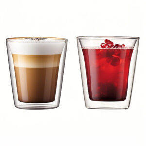 Freshly brewed black coffee inside a clear borosilicate glass coffee cup on a saucer